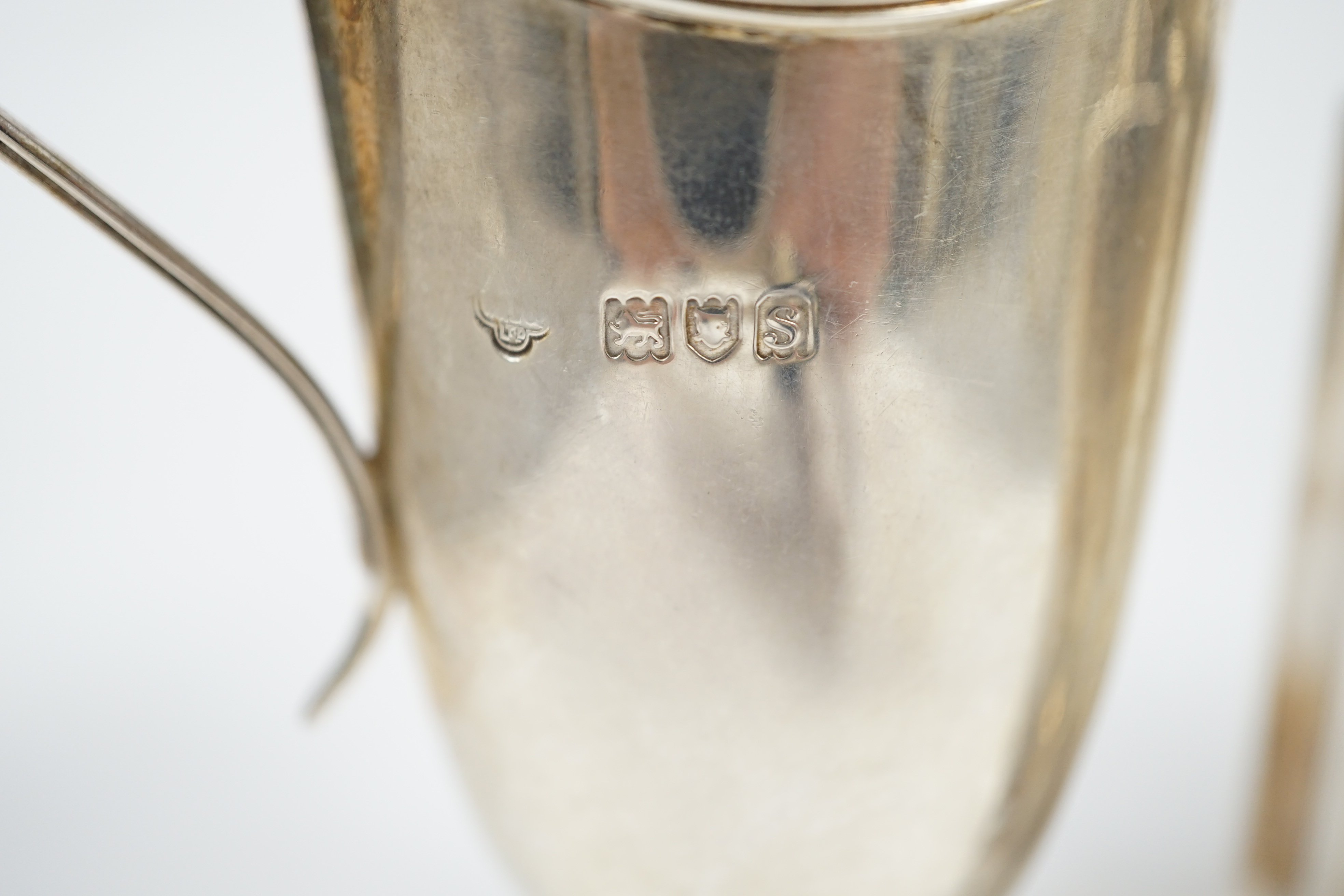 An Edwardian silver ‘bats wing’ tea caddy, Birmingham, 1906, 95mm and a George V silver cream jug. Condition - fair